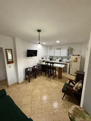 a kitchen and living room with a table and chairs at Finca Marinilla in Marinilla