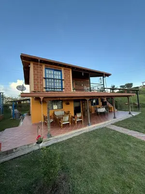 a large house with a deck and a patio at Finca Marinilla in Marinilla