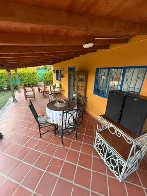 a patio with a table and chairs and a table and chairs at Finca Marinilla in Marinilla
