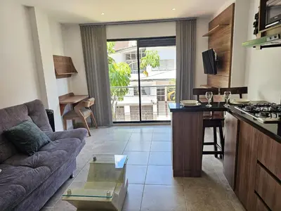 a kitchen and living room with a couch and a table at Laureles Prime Location Medellín Apto Acogedor 301 Zona Tranquila y Cerca a todo in Medellín