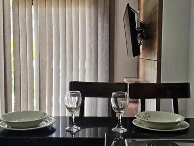 a table with two plates and glasses on it at Laureles Prime Location Medellín Apto Acogedor 301 Zona Tranquila y Cerca a todo in Medellín