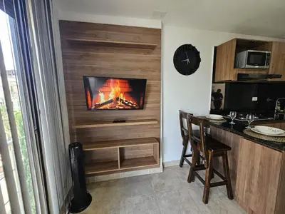 a kitchen with a fire in a wall at Apto Confortable en Zona Exclusiva de Laureles Medellín 401 Tranquilidad y cerca a todo in Medellín