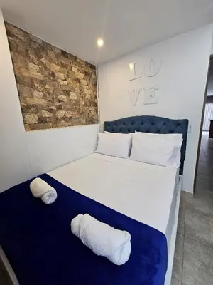 a bedroom with a bed with two pillows on it at Apto Confortable en Zona Exclusiva de Laureles Medellín 401 Tranquilidad y cerca a todo in Medellín