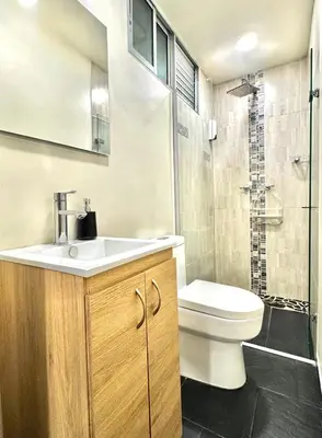 a bathroom with a toilet and a sink and a shower at Apartamento Acogedor y Tranquilo in Sabaneta