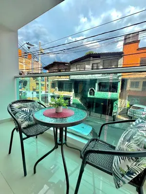 a balcony with a table and two chairs and a window at Apartamento Acogedor y Tranquilo in Sabaneta
