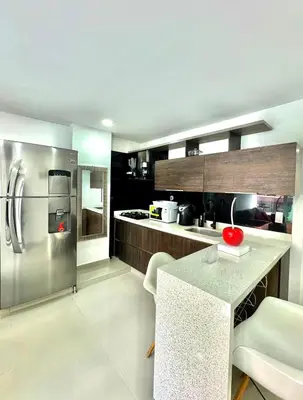 a large kitchen with a stainless steel refrigerator at Apartamento Acogedor y Tranquilo in Sabaneta