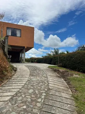 a cobblestone road in front of a building at Casa Alma in Guarne