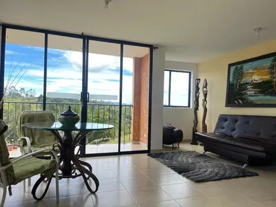 a living room with a table and a couch at Casa Alma in Guarne