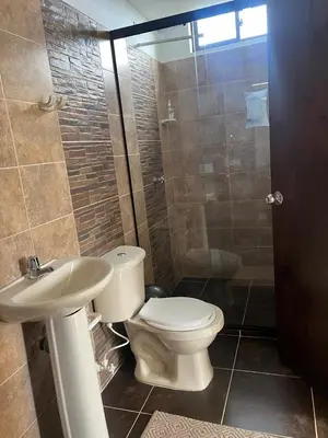 a bathroom with a toilet and a sink and a shower at Casa Alma in Guarne