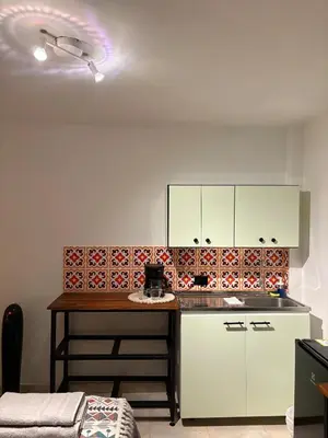 a kitchen with white cabinets and a counter top at Apartamento en centro de Medellín in Medellín