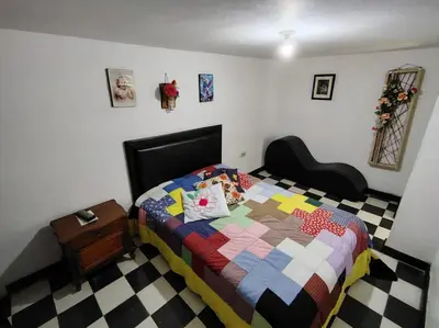 a bedroom with a bed with a quilt on it at Hotel Posada La Porra in Concordia