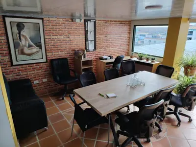 a room with a table and chairs and a brick wall at Hotel Posada La Porra in Concordia