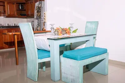 a table with two chairs and a table with flowers on it at Blomst Casa Hostal in Jericó