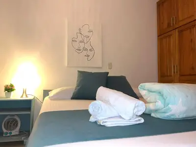 a bedroom with a bed with towels on it at Blomst Casa Hostal in Jericó