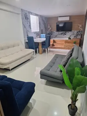a living room with a couch and a table at Luxury laurels in Medellín