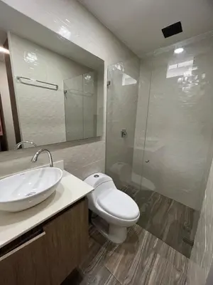 a bathroom with a toilet and a sink and a shower at Luxury laurels in Medellín
