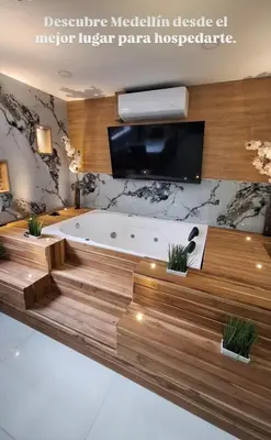 a large bathroom with a tub and a tv at Luxury laurels in Medellín