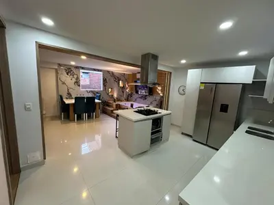 a large kitchen with a stove and a refrigerator at Luxury laurels in Medellín