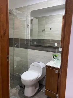 a bathroom with a toilet and a glass shower at Finca a 3 minutos aeropuerto jmc in Rionegro