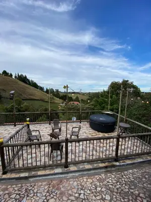 a fence with two chairs and a fire pit at Finca a 3 minutos aeropuerto jmc in Rionegro