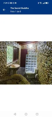 a bathroom with a toilet and a window at Artsy lush villa with jungle garden in the city in La Estrella