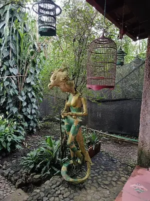 a statue of a woman on a snake at Artsy lush villa with jungle garden in the city in La Estrella