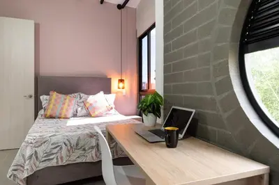 a bedroom with a bed and a desk with a laptop at Cozy Laureles Retreat, Stadium Vicinity in Medellín