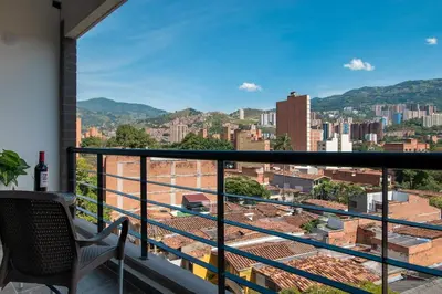 a balcony with a view of a city at Cozy Laureles Retreat, Stadium Vicinity in Medellín