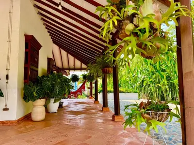 a patio with potted plants in a building at Outstanding FarmHouse jacuzzi & pool near Medellin in Venecia