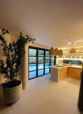 a kitchen with a potted tree in the middle of a room at Macondo House in Medellín