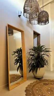 a mirror and two potted plants in a room at Macondo House in Medellín