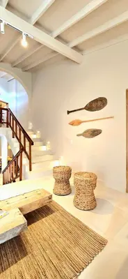 a room with a staircase and wooden stools at Macondo House in Medellín