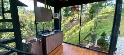 a kitchen with a sink and a large window at Cabañas Bosque Verde in Piedra El Marcial