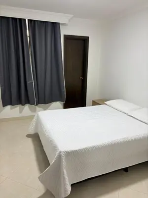 a bedroom with a white bed and a window at Apto en Laureles, 4 Habitaciones Ideal para Grupos in Medellín