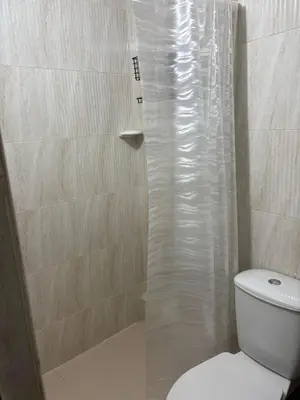 a bathroom with a shower and a white toilet at Apto en Laureles, 4 Habitaciones Ideal para Grupos in Medellín