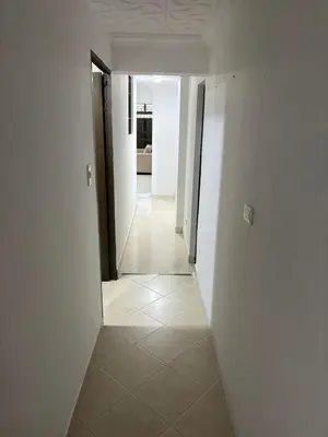 a hallway with white walls and a tile floor at Apto en Laureles, 4 Habitaciones Ideal para Grupos in Medellín