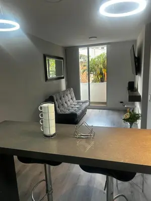 a living room with a couch and a table at Aptosvacacionales Medellín in Medellín
