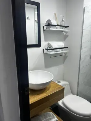a bathroom with a sink and a toilet at Aptosvacacionales Medellín in Medellín