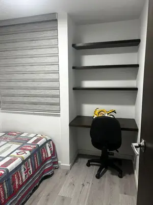 a bedroom with a desk and a chair next to a bed at Aptosvacacionales Medellín in Medellín
