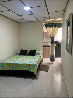 a bedroom with a bed in the middle of a room at La Vide es Bella in Supía