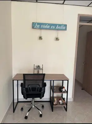 a desk with a chair and a sign that reads air which is better at La Vide es Bella in Supía
