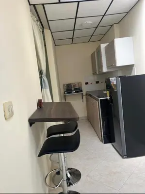 a kitchen with a counter and a stool in a room at La Vide es Bella in Supía