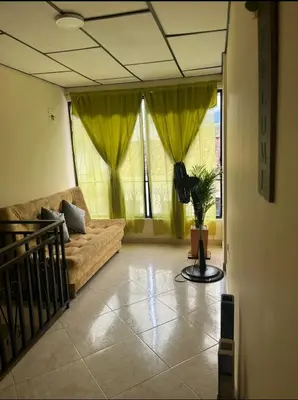 a living room with a couch and yellow curtains at La Vide es Bella in Supía