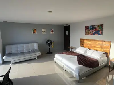 a bedroom with two beds and a couch at Loft en Medellin El Poblado Vista espectacular in Medellín