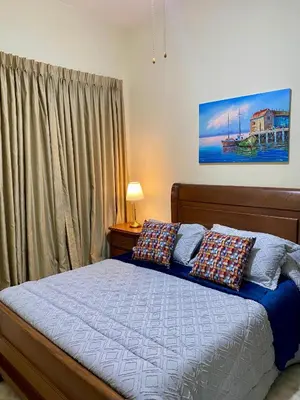 a bedroom with a bed with pillows on it at Apartamento Central Envigado in Envigado