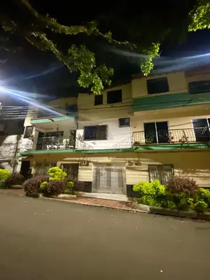 a white building with windows and a street at night at Apartamento Central Envigado in Envigado