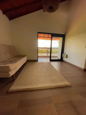 a living room with a couch and a large rug at Apartamento en Guarne-Antioquia in Guarne