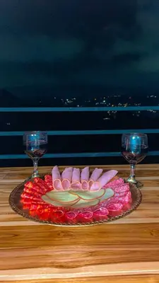 a plate of food on a table with two wine glasses at Apartamento en Guarne-Antioquia in Guarne