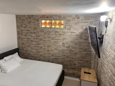 a room with a bed and a brick wall at Apartamento en la mejor zona de buenos aires in Medellín