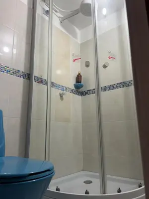 a shower with a blue toilet in a bathroom at Apartamento en la mejor zona de buenos aires in Medellín